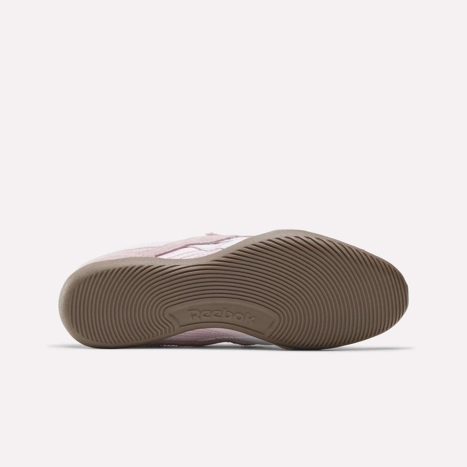 The Women's Ultra Lo Mary Jane Shoes by Reebok in pink feature a low-profile design, a textured brown rubber sole, and the Reebok logo embossed in the arch—classic everyday comfort with modern style.