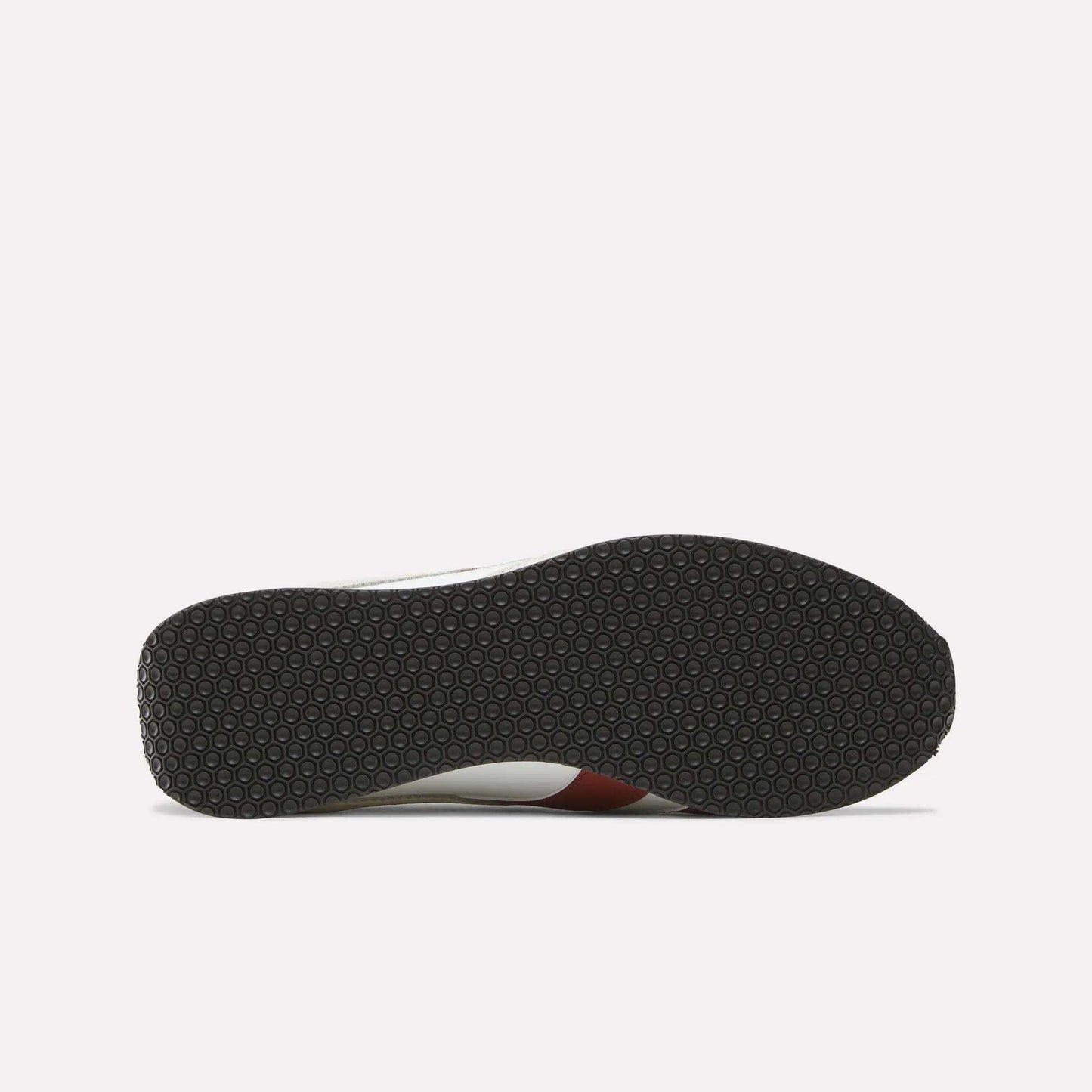 The image shows the bottom view of the Reebok R400 Shoes, featuring a black rubber sole with a repeating hexagonal pattern, a hallmark of many retro sneakers. The rest of the shoe is only partially visible from this angle.