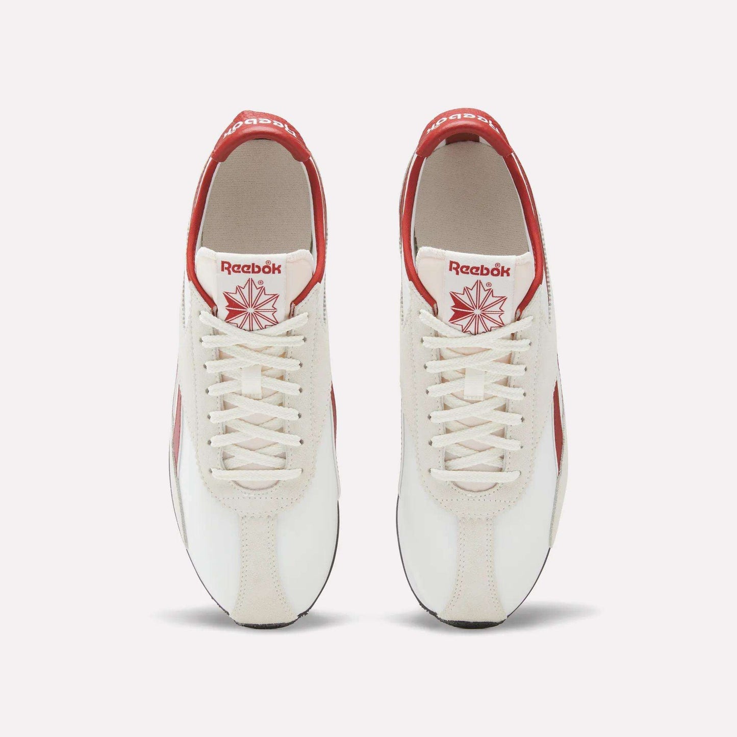 Top view of a pair of Reebok R400 Shoes in white with red accents, featuring white laces and red Reebok logos on the tongue and heel. These vintage Reebok sneakers are placed side by side on a plain background.