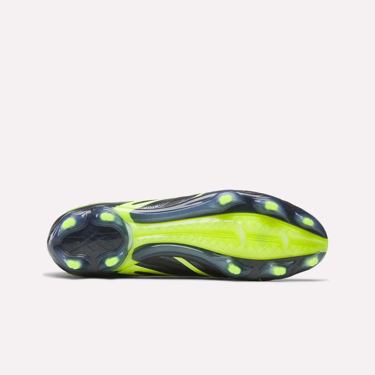 Bottom view of the Reebok Sidewinder 26 Elite FG Cleats showing a black and neon yellow sole designed for firm grass, with six round studs and textured grip patterns to boost traction and ball control.