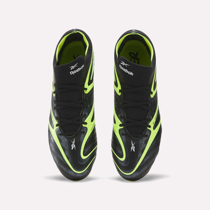 A pair of Reebok Sidewinder 26 Elite FG Cleats, shown from above, with black uppers, neon yellow accents, and white logos—designed for firm ground play and superior ball control.