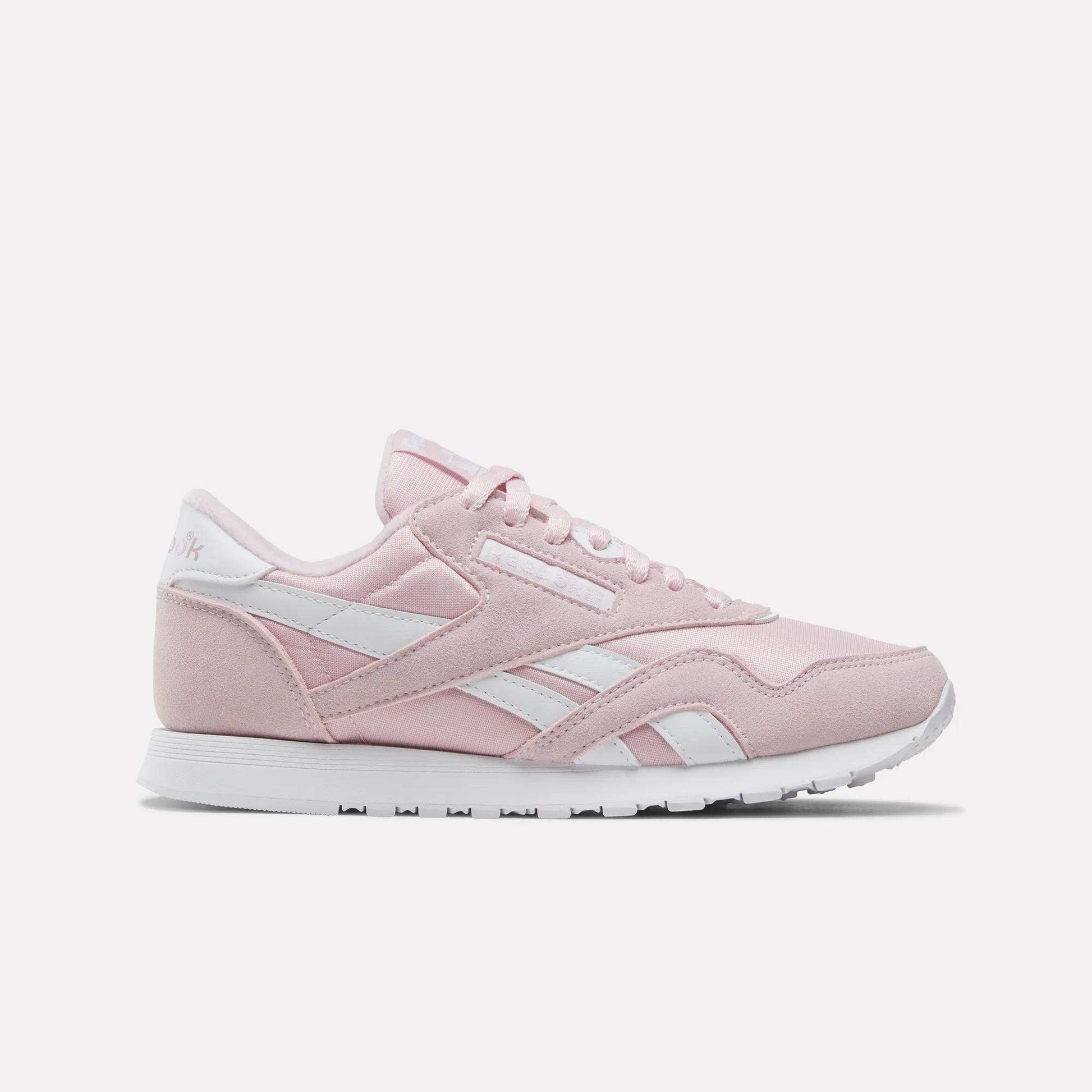 Showcased on a plain white background, the Reebok Women's Classic Nylon Shoes come in Elemental Pink with white accents and laces, featuring the iconic retro design and a white rubber sole—an ideal addition to any women's shoe collection.