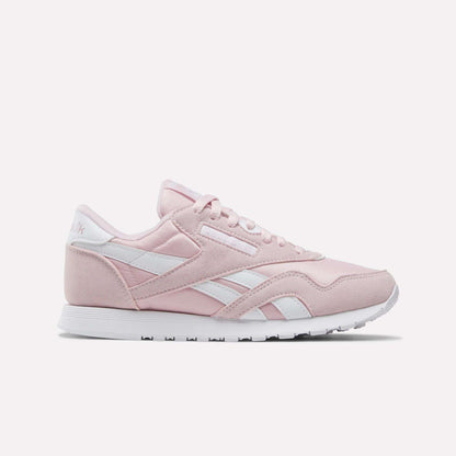 Showcased on a plain white background, the Reebok Women's Classic Nylon Shoes come in Elemental Pink with white accents and laces, featuring the iconic retro design and a white rubber sole—an ideal addition to any women's shoe collection.