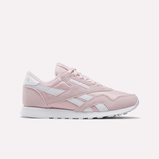 Showcased on a plain white background, the Reebok Women's Classic Nylon Shoes come in Elemental Pink with white accents and laces, featuring the iconic retro design and a white rubber sole—an ideal addition to any women's shoe collection.