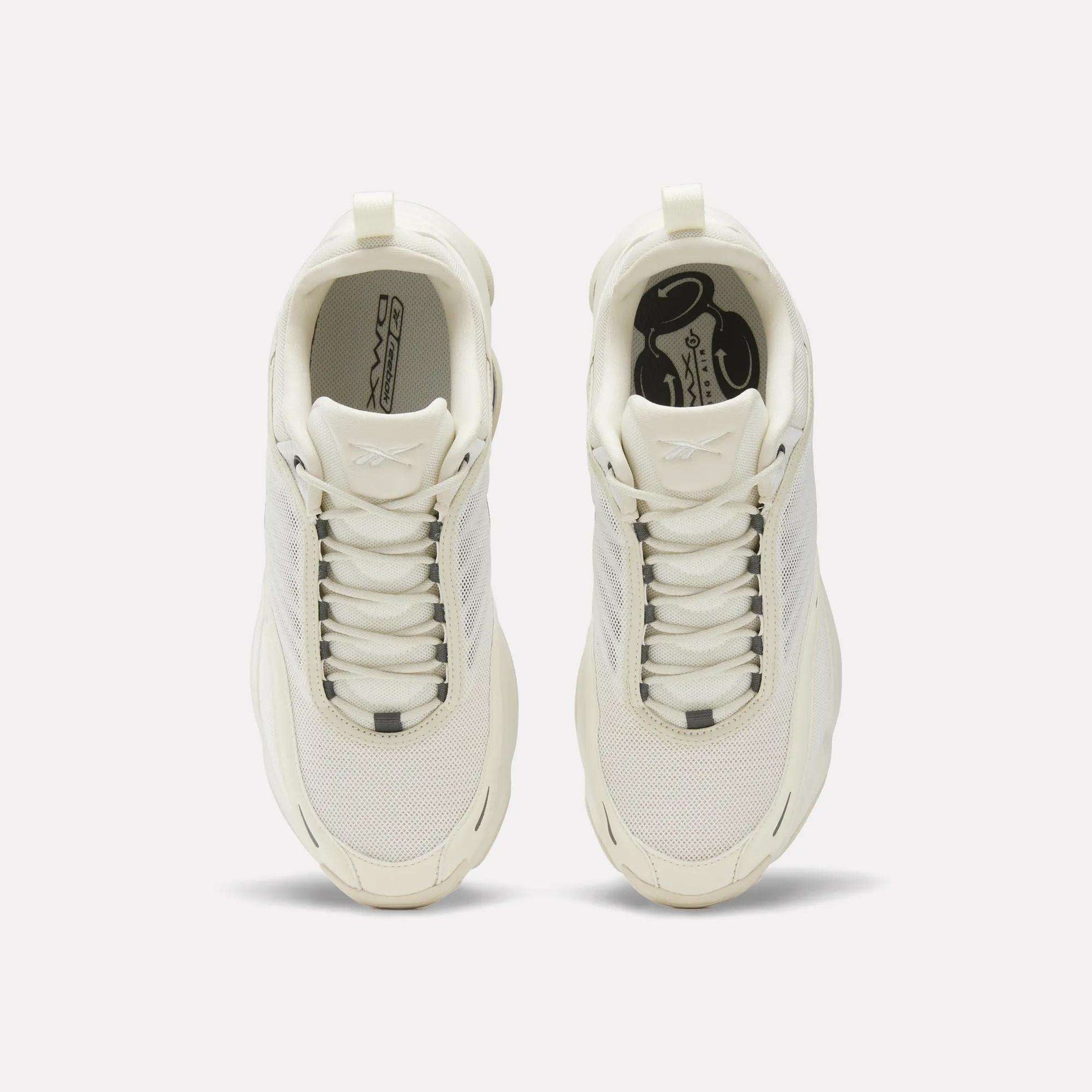 Top view of Reebok DMX Series 3000 Shoes in white, featuring mesh and synthetic overlays, white laces, and logos on the insoles and tongues—crafted for comfort with innovative DMX moving air technology on a plain light background.
