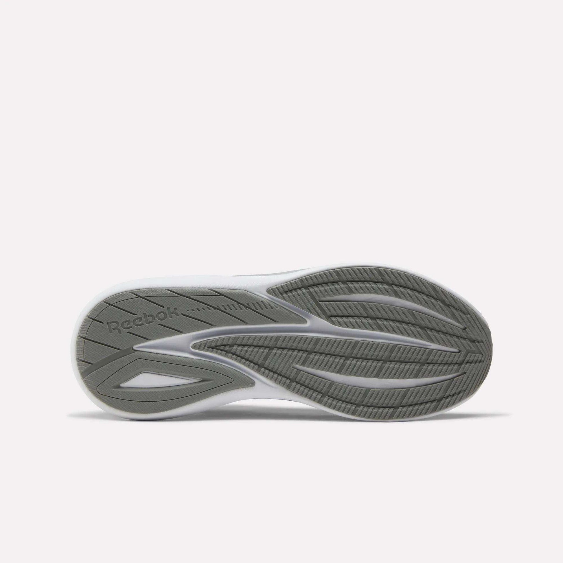 The image displays the sole of the Reebok Men's Viva Speed Shoes, featuring a grey and white pattern, textured grooves for added cushioning, enhanced grip and traction, and the Reebok logo embossed on the left side.
