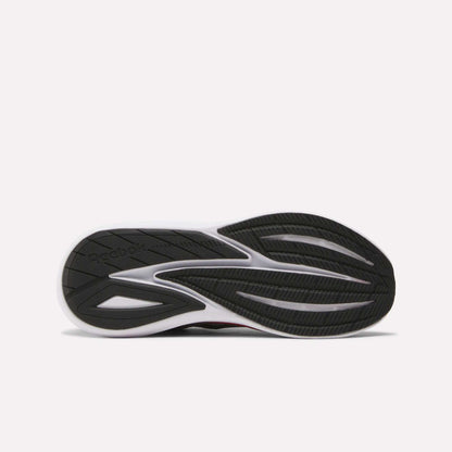 The image shows the black and white rubber outsole of Reebok Men's Viva Speed Shoes, laid flat to display the tread pattern and logo—engineered to pair seamlessly with the breathable mesh upper for comfort and performance.