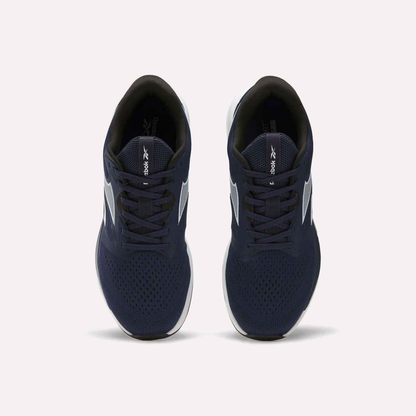 Top view of Reebok Men's Nanoflex Trainer 2 Shoes featuring navy blue uppers, white soles, and black interiors, displayed side by side on a plain white background.