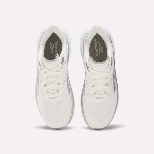 A top view of the Men's Viva Speed Shoes by Reebok, featuring white uppers, light gray side accents, white laces, and gray Reebok logos on the insoles. These breathable shoes are shown on a light background.