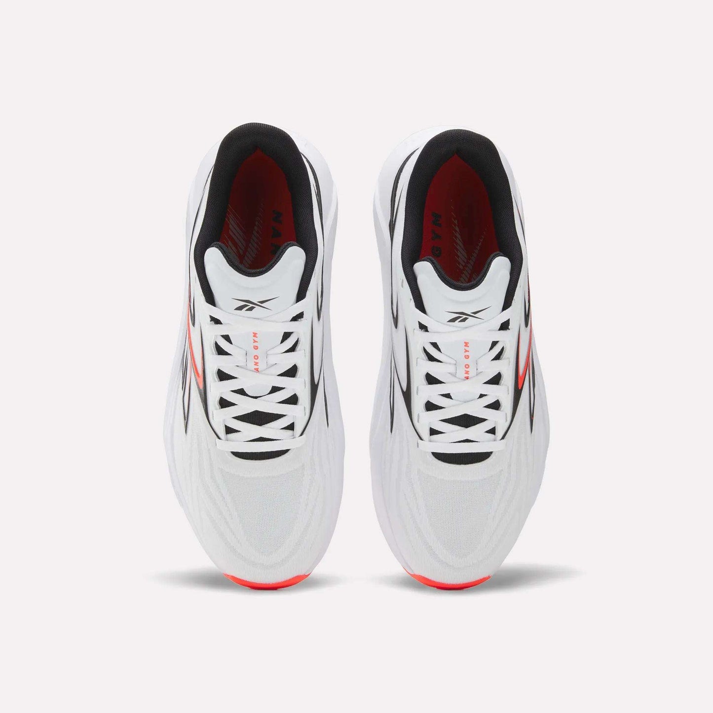 Top view of Reebok Nano Gym 2.0 Training Shoes in white, featuring black laces, high-rebound foam soles with red side accents, a black interior lining, and subtle gray upper detailing.