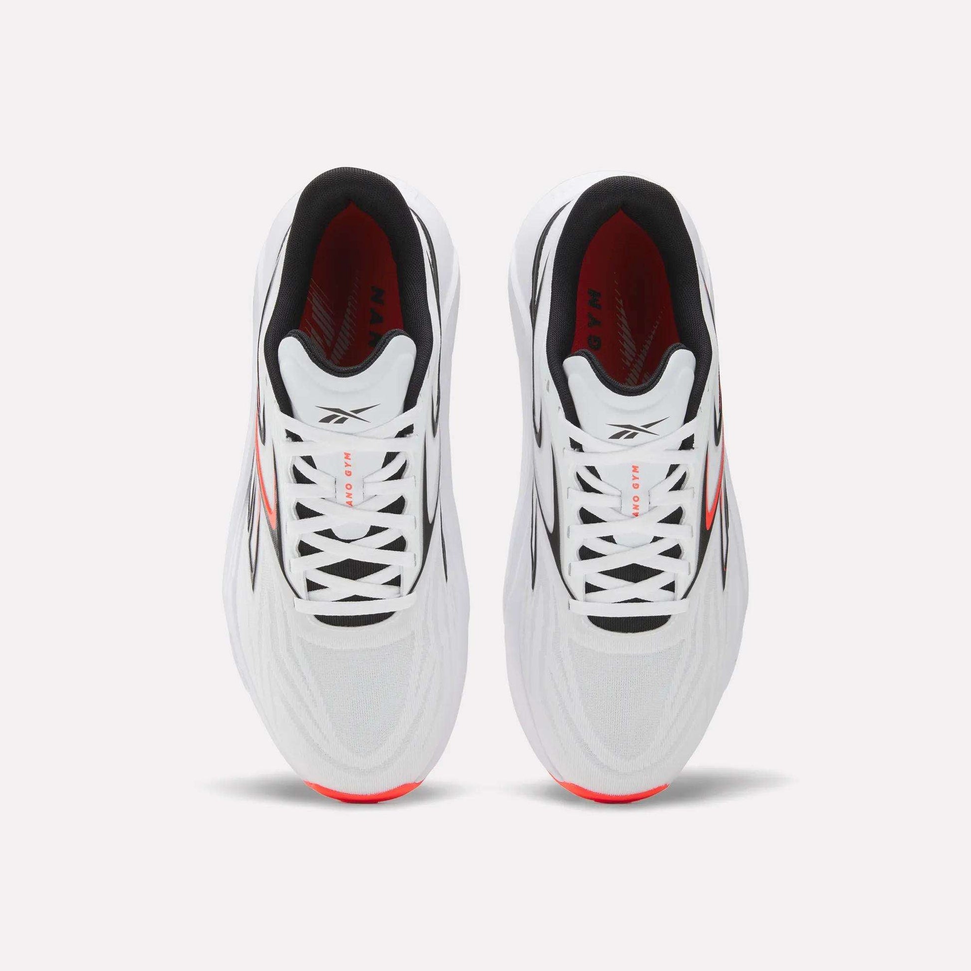 Top view of Reebok Nano Gym 2.0 Training Shoes in white, featuring black laces, high-rebound foam soles with red side accents, a black interior lining, and subtle gray upper detailing.
