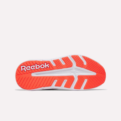 The image displays the sole of the Women's Nano Gym 2.0 Training Shoes by Reebok, mainly white with vibrant red and orange accents, featuring the bold white Reebok logo on a red background near the heel.