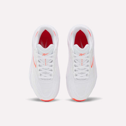Top view of Women's Nano Gym 2.0 Reebok training shoes in white with red side and interior accents, white laces, and a subtle Reebok logo on the tongue.