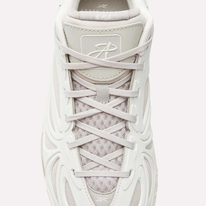 Top view of the Reebok Angel Reese 1 Basketball Shoes in white with textured mesh, light gray laces, molded side design, a stylized tongue logo, and Energy Return System for enhanced basketball performance.