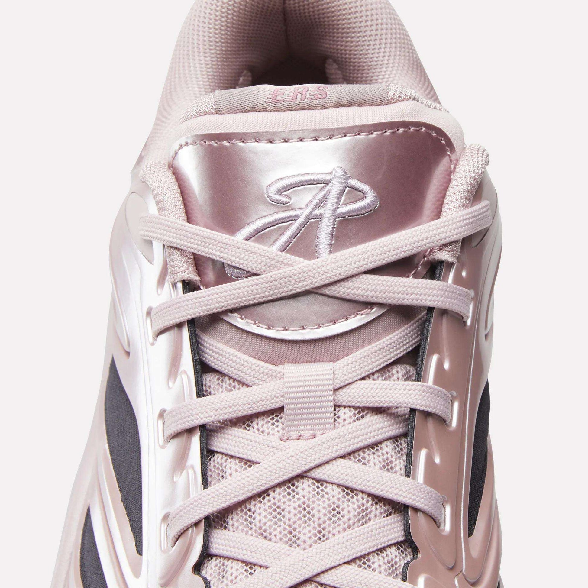 Top view of the Reebok Angel Reese 1 Basketball Shoes: features light pink laces, a shiny pink tongue with a stylized A logo, and mesh fabric with plastic accents—evoking Angel Reese's signature style.