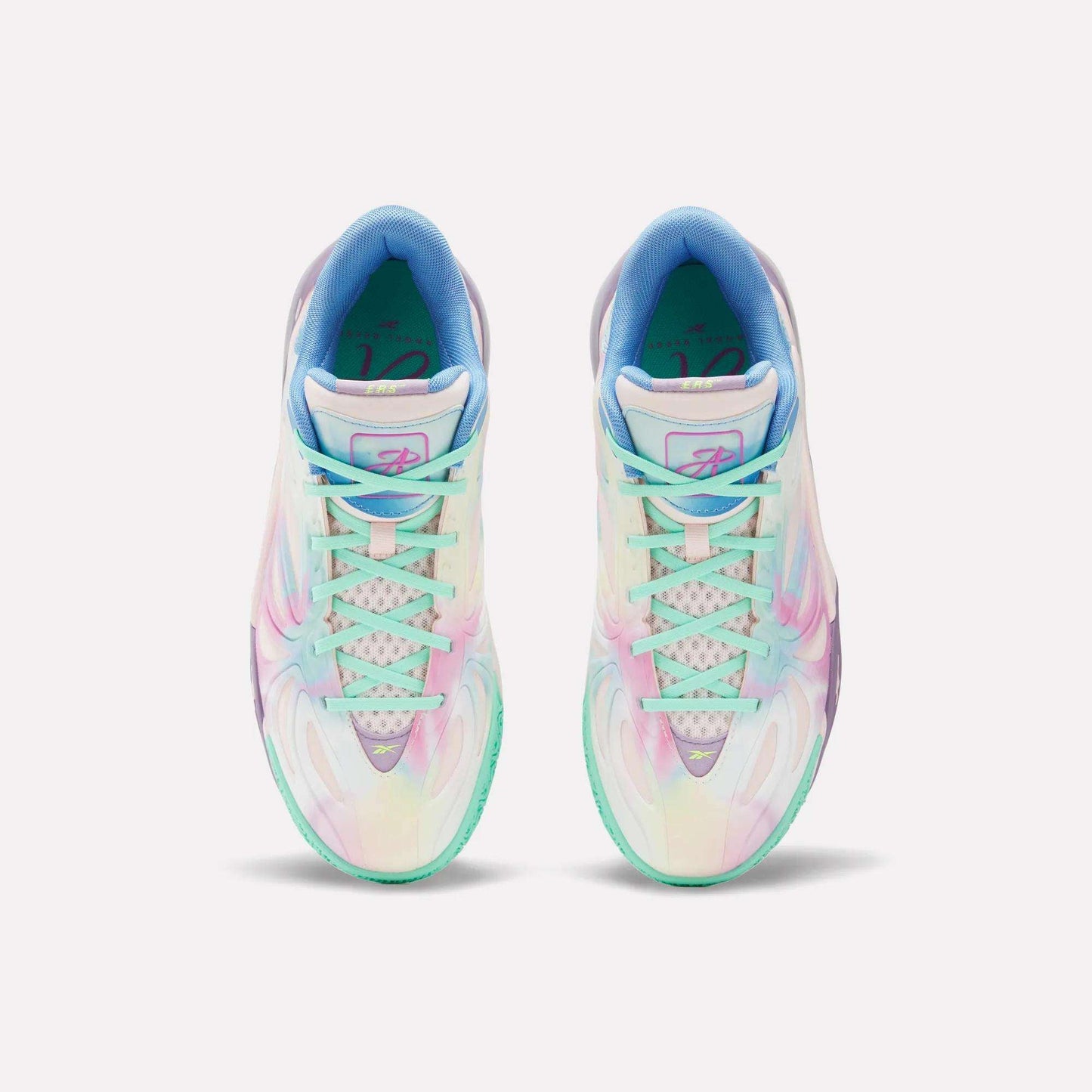 Top view of the Reebok Angel Reese 1 Basketball Shoes, showcasing colorful pastel hues, gradient patterns, white soles, and a light blue inner lining, inspired by performance basketball designs and displayed on a plain white background.