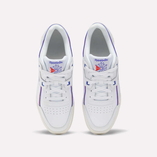 A pair of Women's Club C 85 Shoes by Reebok in white leather with purple accents and a blue and orange Reebok logo on the tongue, shown from above on a light background—classic women's sneakers with timeless style.