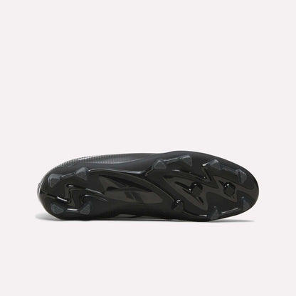 The image displays the black, textured sole of the Reebok Strike Multi Ground Soccer Cleats, featuring molded studs for turf traction, as seen from the bottom against a plain white background.