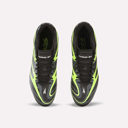 Top view of black and neon green Reebok Sidewinder 26 League FG Cleats for big kids, featuring black laces, firm ground studs, and prominent Reebok logos on the tongues and sides, placed side by side on a plain white background.