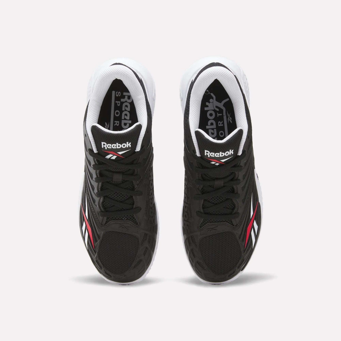 Top view of Reebok Phase EVO Tennis Shoes in black with white soles and red-white accents, featuring Reebok Sport branding on the tongue and insole—durable, responsive tennis shoes shown on a plain white background.