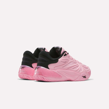 Two pink Angel Reese 1 Shoes by Reebok, featuring black inner lining and heel accents, are displayed against a plain white background. Showcasing a textured sole and wavy side patterns, these performance basketball shoes are inspired by Angel Reese and crafted to elevate your game with the advanced Reebok Energy Return System for responsive comfort on the court.