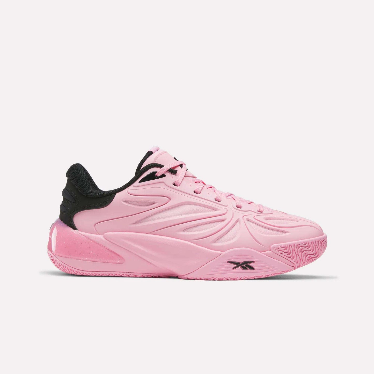 Introducing the Angel Reese 1 Shoes by Reebok in Expressive Pink with black collar and outsole accents. Featuring a textured sole and the signature Reebok logo on the side, this design takes inspiration from performance basketball footwear and incorporates the innovative Reebok Energy Return System for responsive comfort both on and off the court.