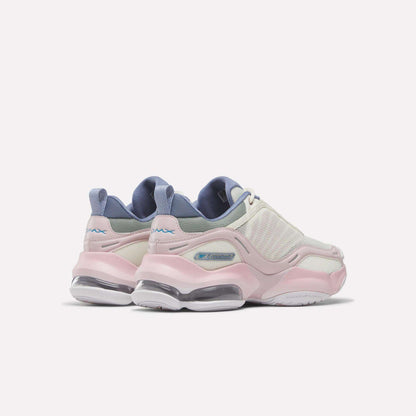 A pair of pastel-colored sneakers—the Women's DMX Series 3000 Training Shoes by Reebok—featuring pink soles, white mesh uppers, lilac accents, and advanced DMX 3 Technology for enhanced comfort, displayed against a plain white background.