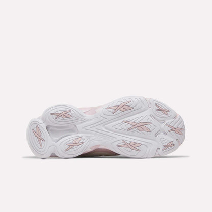 The image displays the sole of the Reebok Women's DMX Series 3000 Training Shoes, featuring a predominantly white base with subtle light pink accents and textured grip patterns. Photographed against a plain light background, this innovative design exemplifies the comfort and style characteristic of Reebok's footwear, making it ideal for everyday training and active wear.