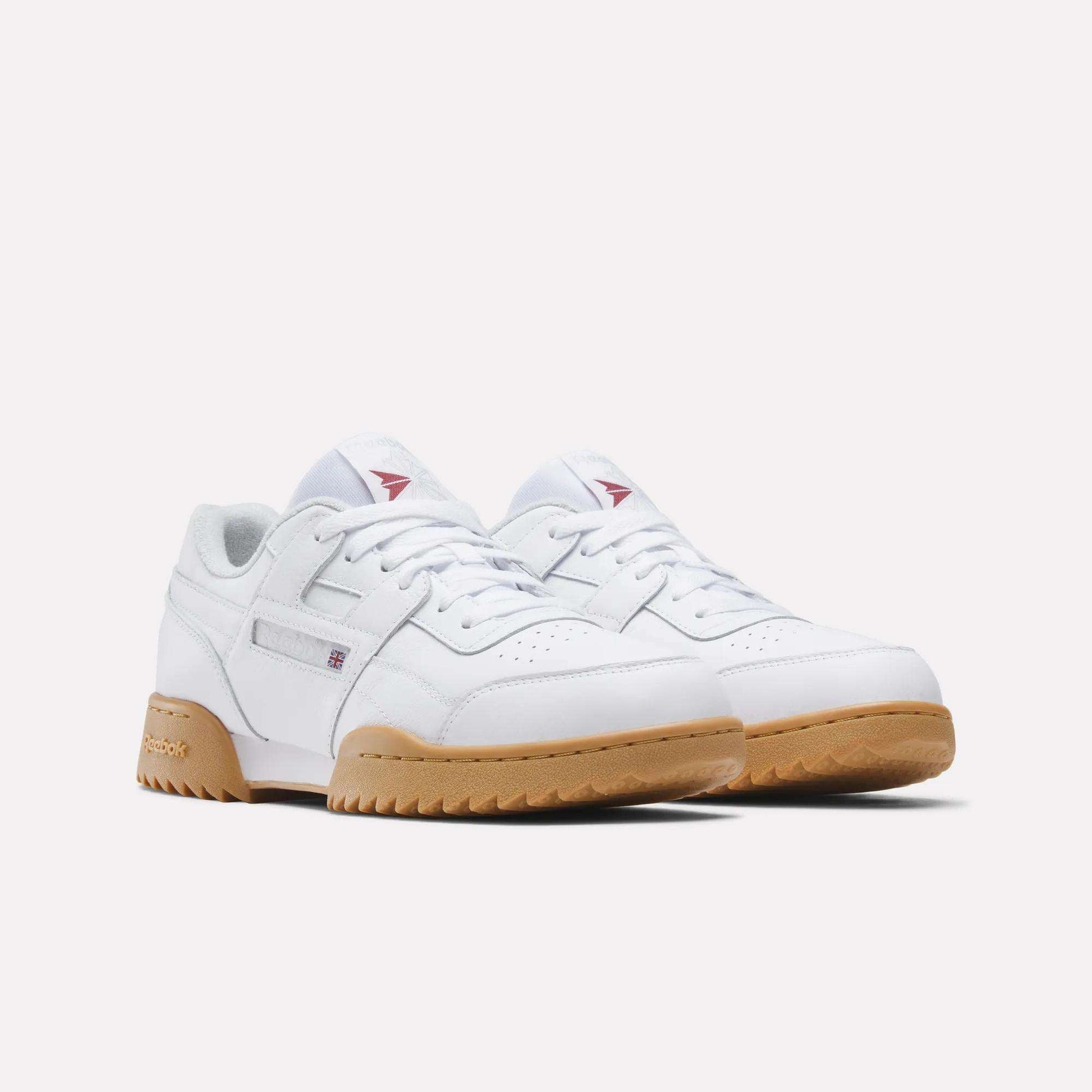 The Reebok Workout Plus Ripple Shoes feature white leather uppers, tan rubber ripple soles, subtle stitching, and small red and blue branding details, offering a vintage vibe against a plain white background.
