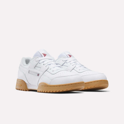 The Reebok Workout Plus Ripple Shoes feature white leather uppers, tan rubber ripple soles, subtle stitching, and small red and blue branding details, offering a vintage vibe against a plain white background.