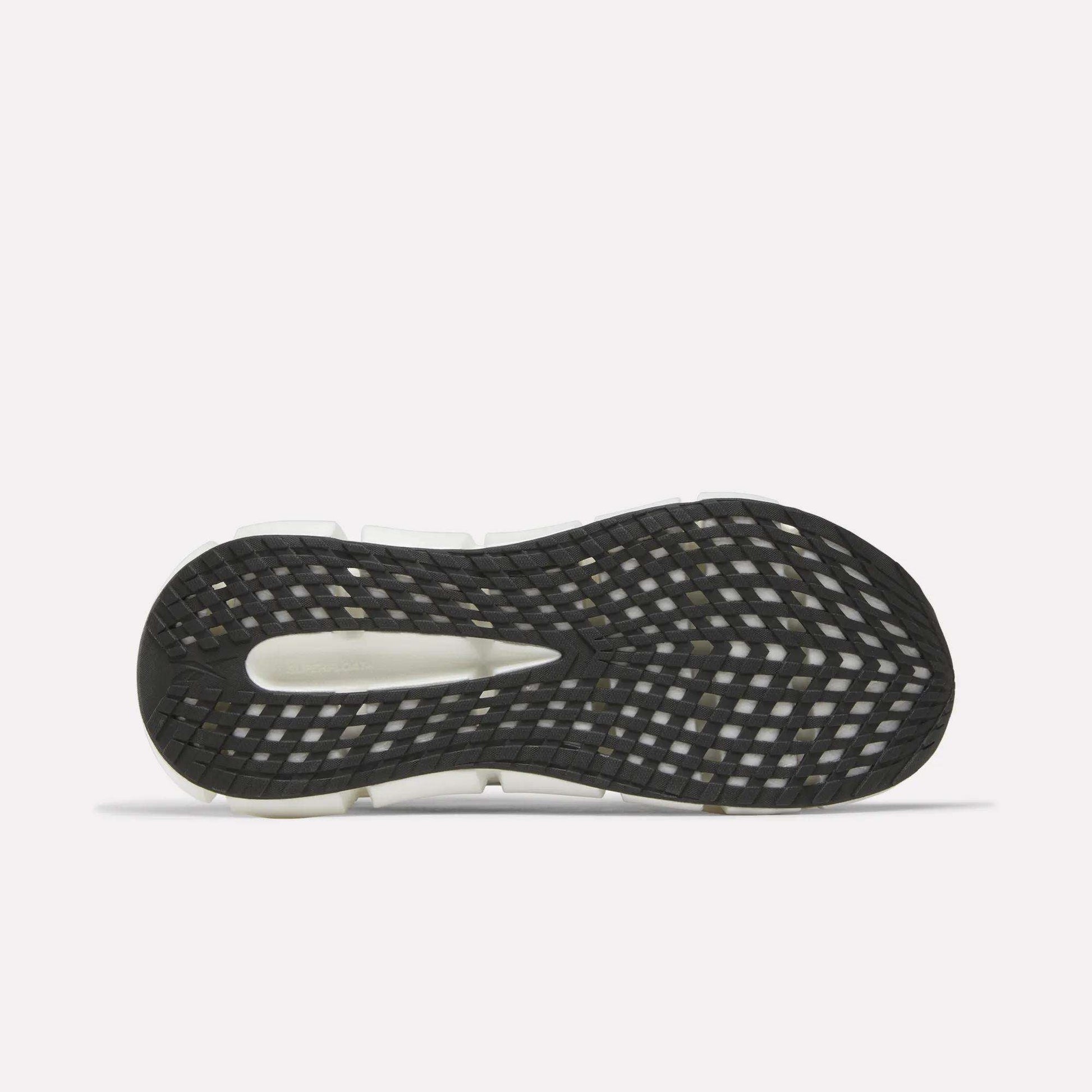 The image shows the black sole of the Reebok Men's FloatZig 2 Running Shoes with a white midsole and grid-like traction pattern, featuring Superfloat+ cushioning. The shoe is flat with the sole facing up on a plain white background.