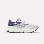 The Reebok Men's FloatZig 2 Running Shoes feature a white and navy mesh upper, Superfloat+ cushioning, thick segmented white sole, navy and black accents, and Reebok logos on the heel and side.
