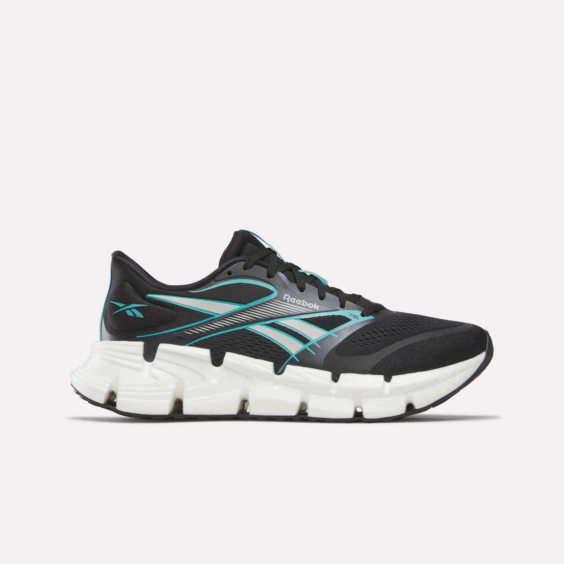 The Reebok Men's FloatZig 2 Running Shoes feature a black athletic design with teal accents and a thick, segmented white sole for energy-returning cushioning, shown in side profile against a plain light background.