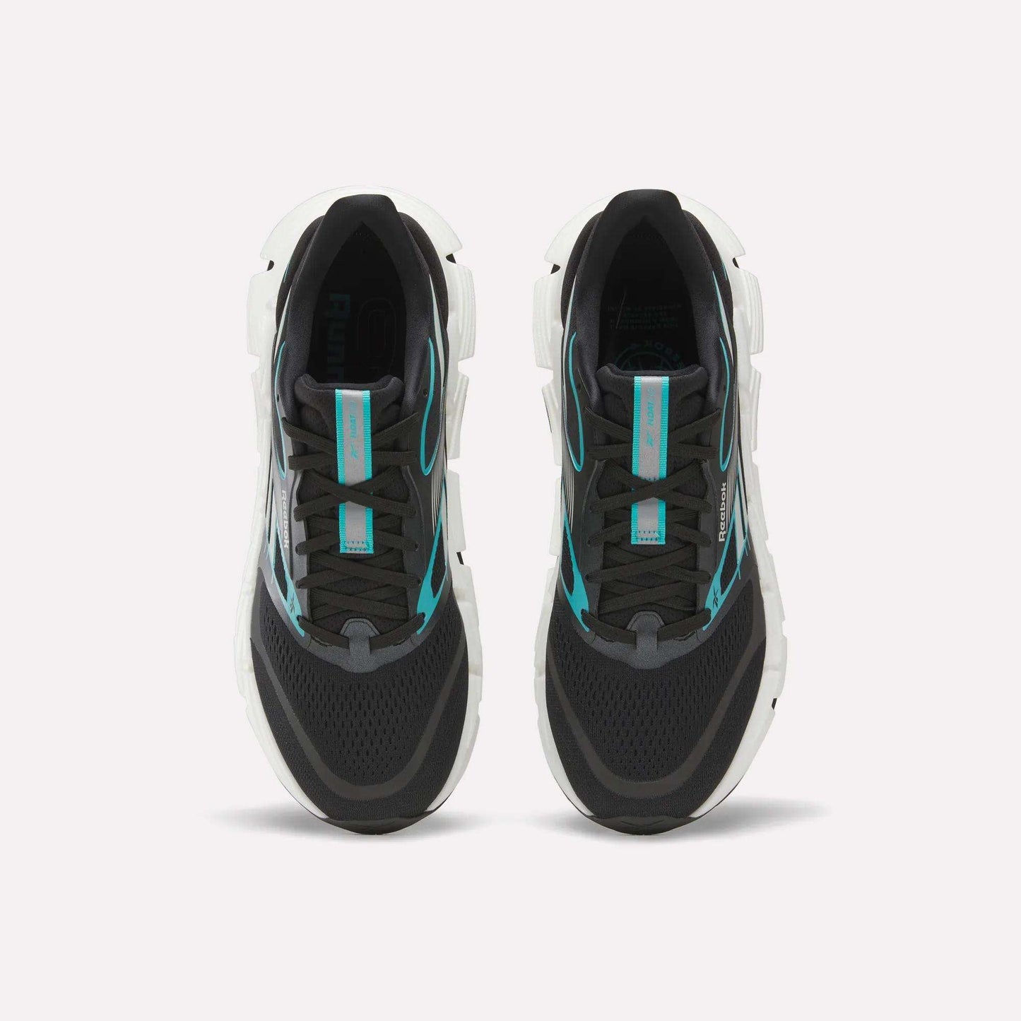A pair of Men's FloatZig 2 Running Shoes by Reebok, black with white soles and turquoise accents, featuring Superfloat+ cushioning, shown side by side from above on a plain white background.