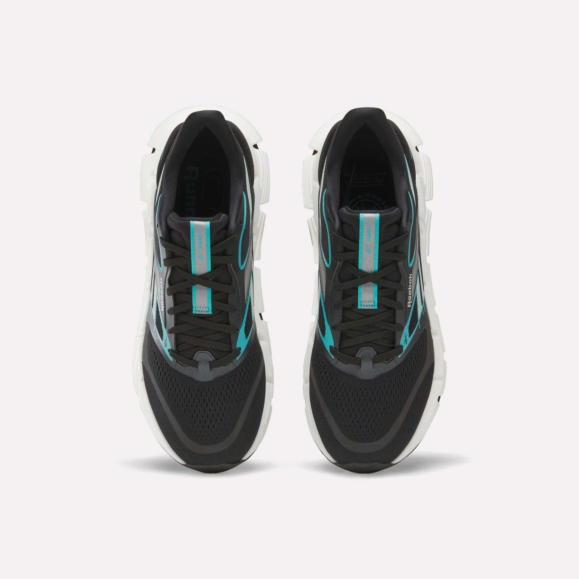 A pair of Men's FloatZig 2 Running Shoes by Reebok, black with white soles and turquoise accents, featuring Superfloat+ cushioning, shown side by side from above on a plain white background.