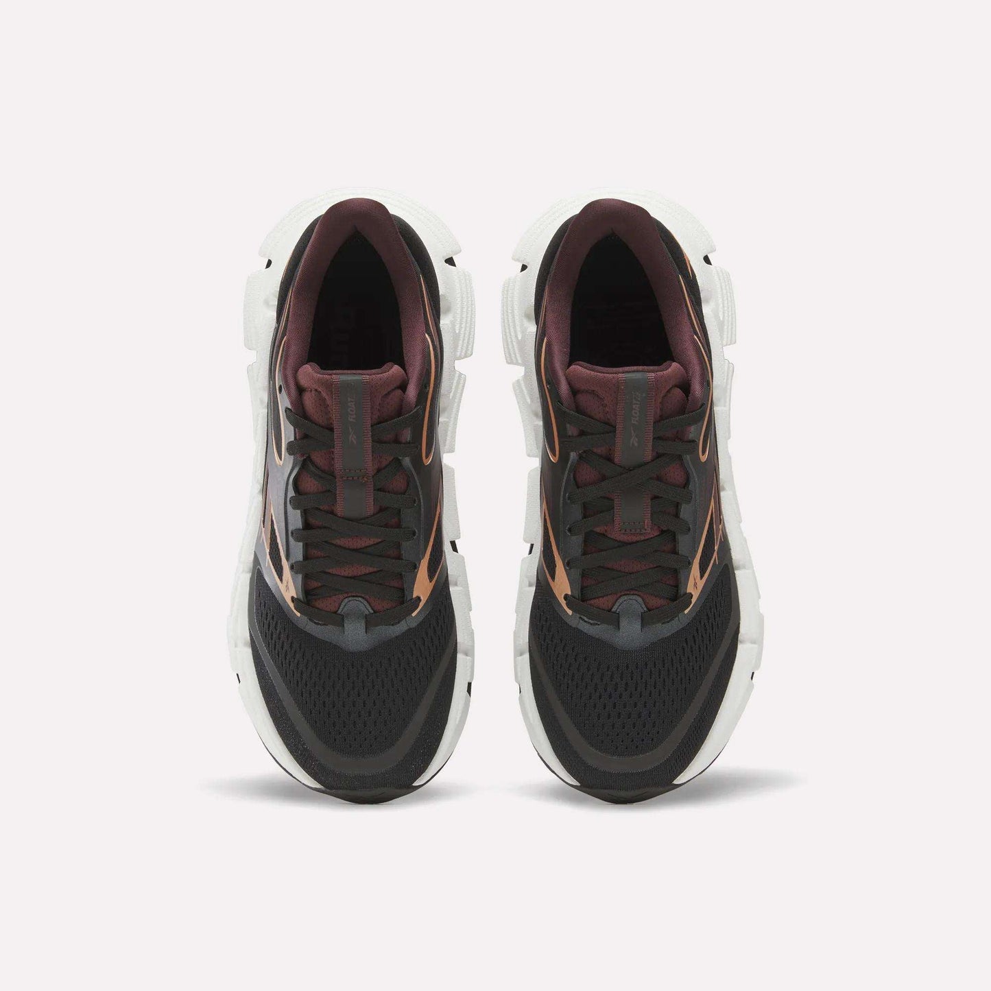 A pair of Reebok Women's FloatZig 2 Running Shoes seen from above, with black mesh toes, dark maroon tongues and collars, brown accents, and thick white Superfloat+ cushioned soles against a light background.