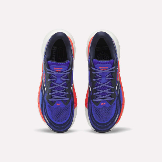 The Reebok Men's FloatZig Double Running Shoes feature a purple upper with blue and red accents, StableStack max cushioning, white midsoles, black interiors, purple laces, and the Reebok logo on the tongue.