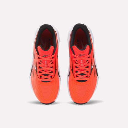 Top view of Reebok Nano Gym 2.0 Training Shoes in bright red with white soles, black and white accents, high-rebound foam, and red laces, displayed side by side on a plain white background.