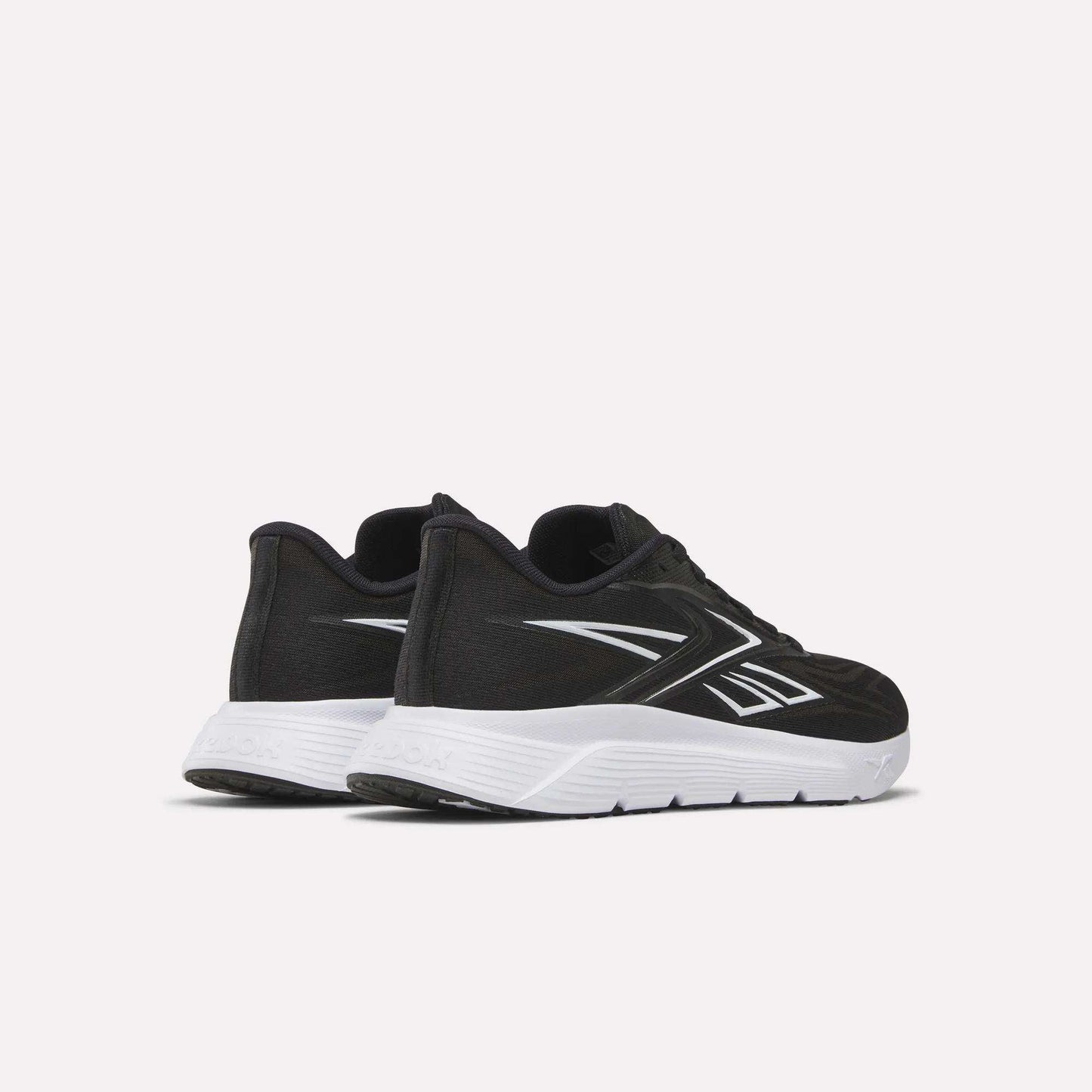 Women's Nano Gym 2.0 Training Shoes by Reebok in black with white soles and silver accents, displayed from the back and side on a plain white background.