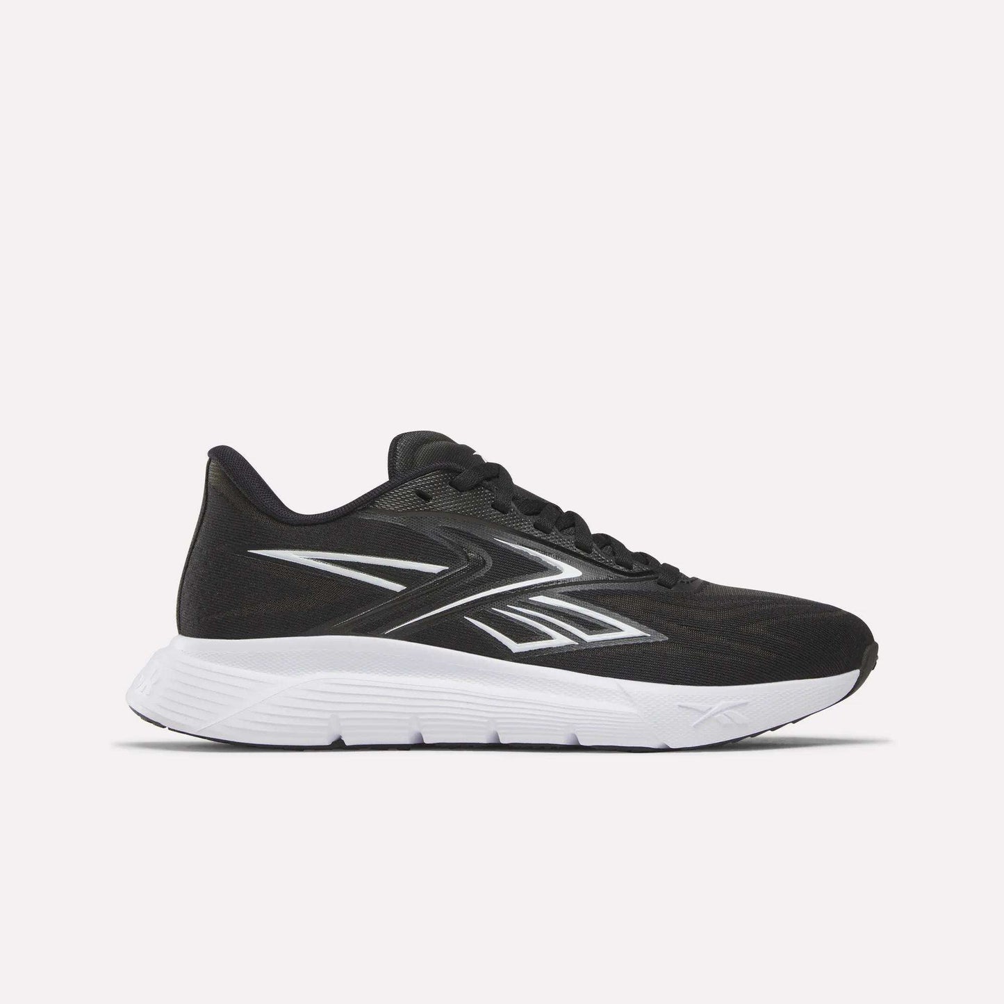 The Reebok Women's Nano Gym 2.0 Training Shoes in Black/Ftwr White are shown side view, highlighting their white sole and lace-up design against a plain light background.