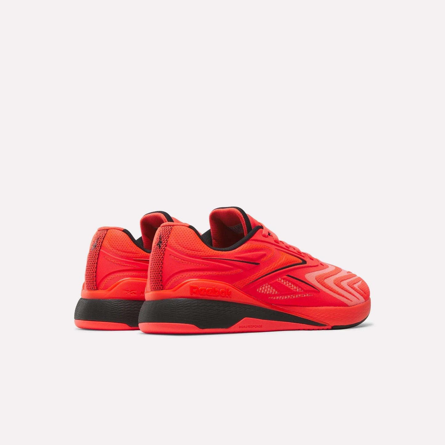 A pair of Reebok Nano X5 Edge Training Shoes in bright red with black soles and accents, displayed from rear and side angles against a white background.