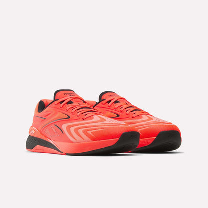 The Reebok Nano X5 Edge Training Shoes feature a bright orange upper with black soles and accents, boasting a sleek, modern design for peak performance. Seen here on a white background.