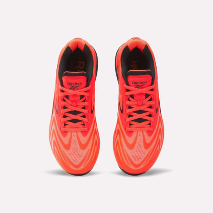 Top view of Reebok Nano X5 Edge Training Shoes in bright orange with black accents and wavy patterns, featuring laces and logo on the tongues, designed for peak performance on a white background.