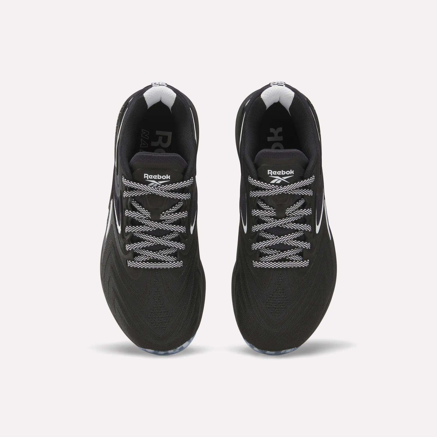 Top view of Reebok Women's Nano X5 Edge Training Shoes in black with white laces and accents, displayed side by side on a plain white background.