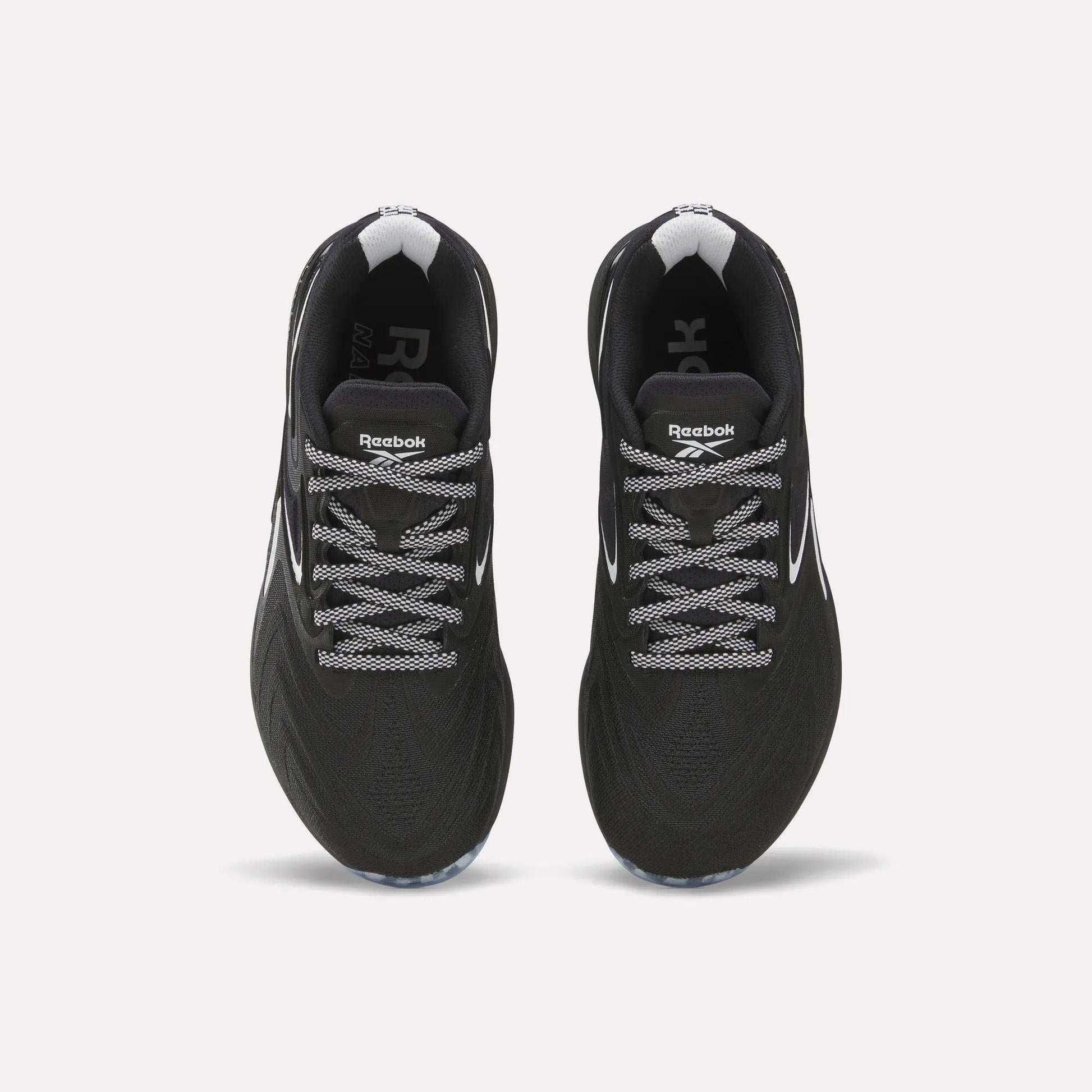 Top view of Reebok Women's Nano X5 Edge Training Shoes in black with white laces and accents, displayed side by side on a plain white background.