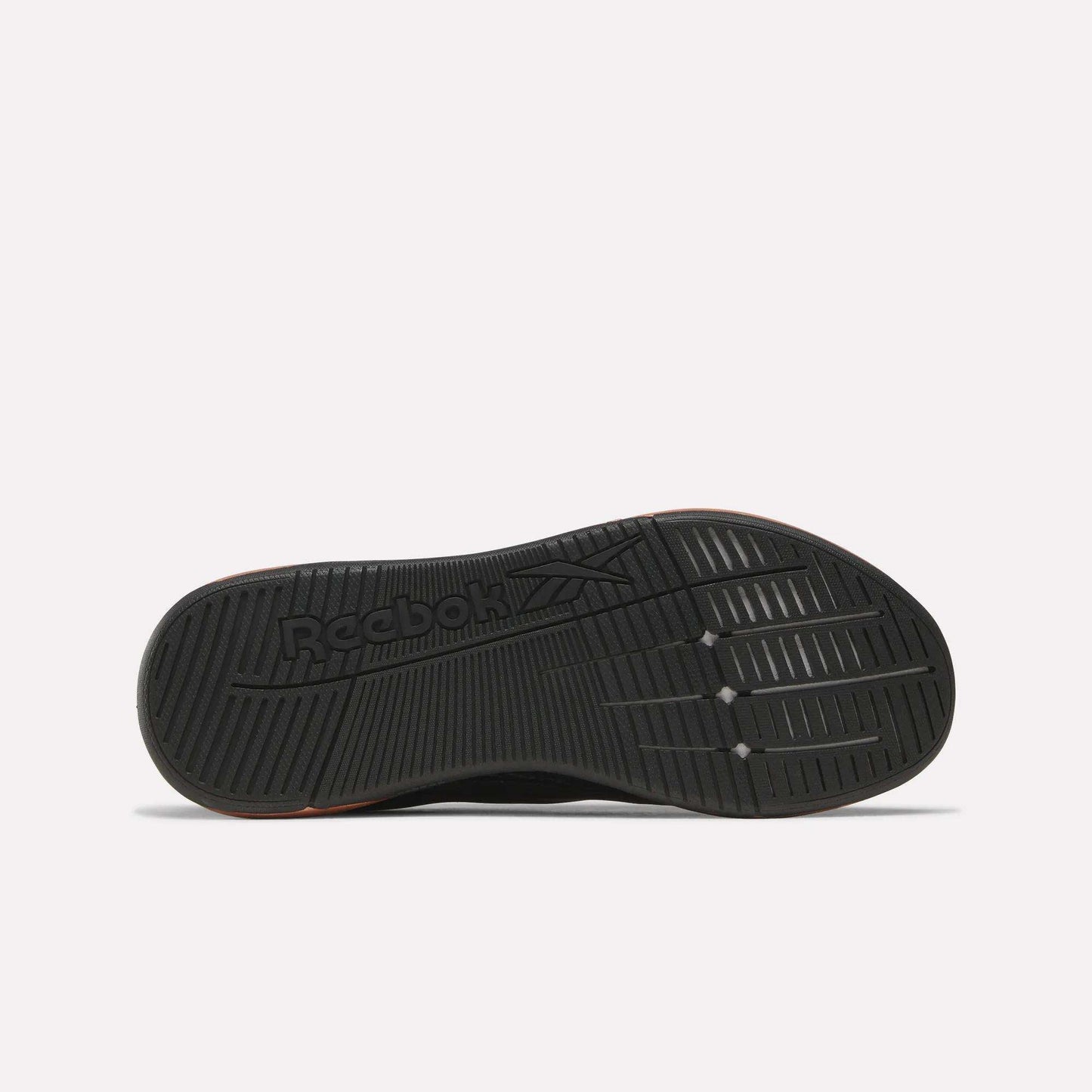 The image displays the black rubber outsole of Reebok Women's Nano X5 Edge Training Shoes, featuring grooved traction patterns and the Reebok logo. The shoe is shown sole-up on a plain white background—ideal for HIIT class.