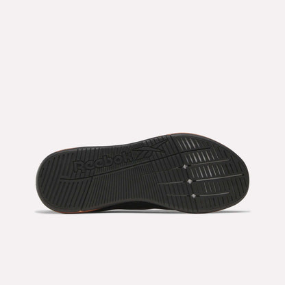 The image displays the black rubber outsole of Reebok Women's Nano X5 Edge Training Shoes, featuring grooved traction patterns and the Reebok logo. The shoe is shown sole-up on a plain white background—ideal for HIIT class.