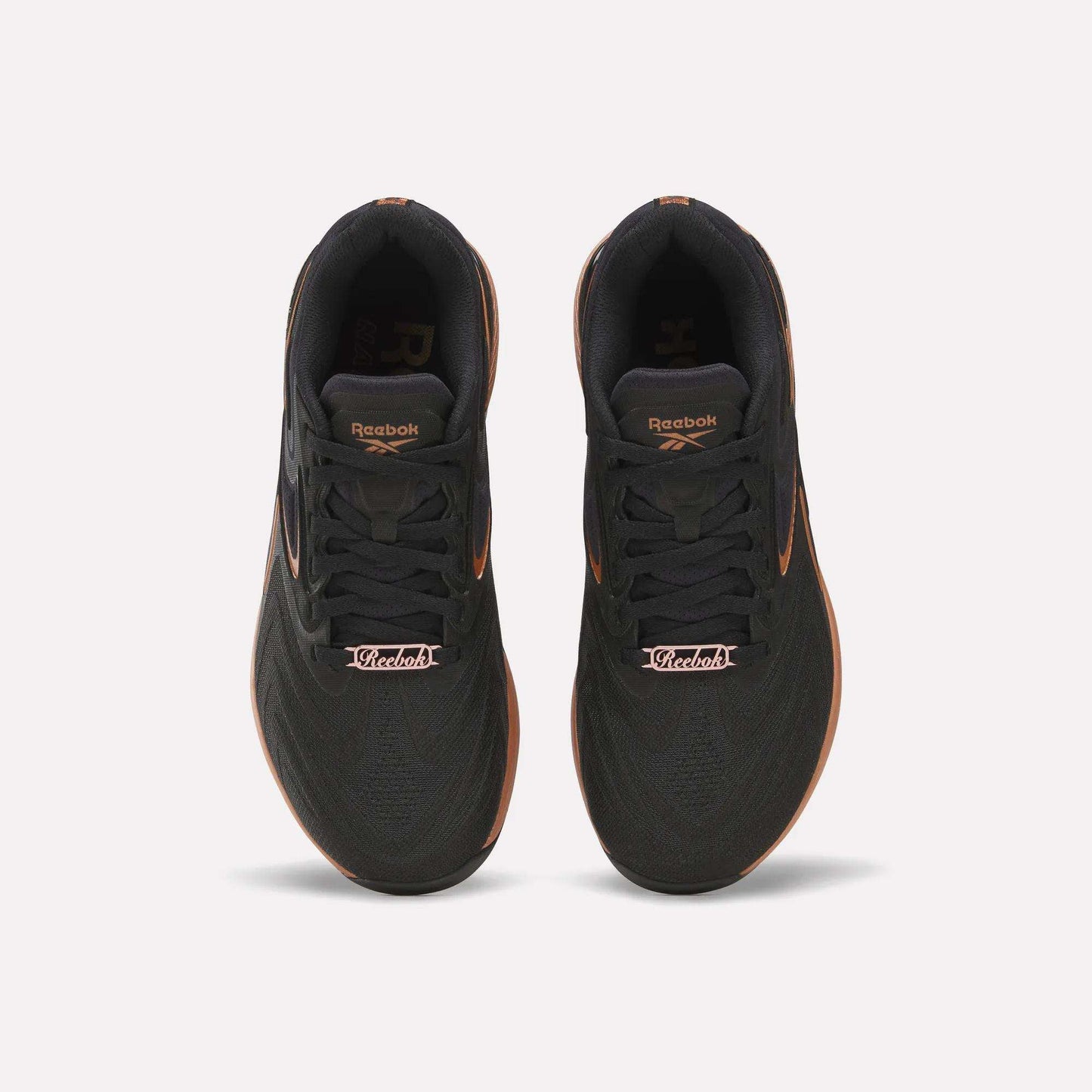 Top view of Reebok Women's Nano X5 Edge Training Shoes in black with orange accents and “Victoria” on the laces—ideal for your next HIIT class.