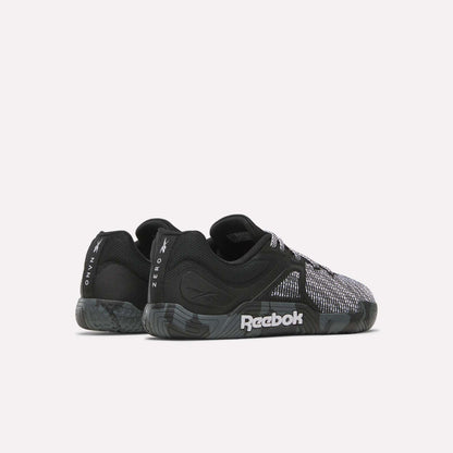 A pair of black and gray Reebok Nano Zero Training Shoes with textured soles and mesh details, ideal for strength training. Viewed from the side and slightly angled to the back. The Reebok logo is visible on the sole and heel.