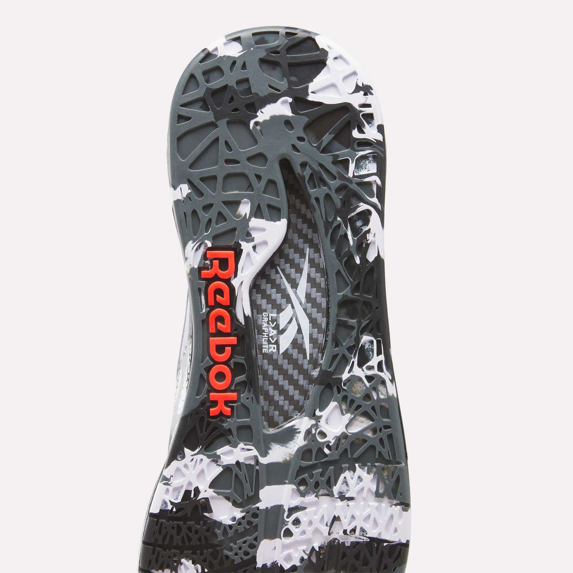 Close-up of the Reebok Nano Pro Training Shoes sole featuring a black and white abstract pattern, geometric texture, SuperFloat foam cushioning, and a red Reebok logo on the heel.